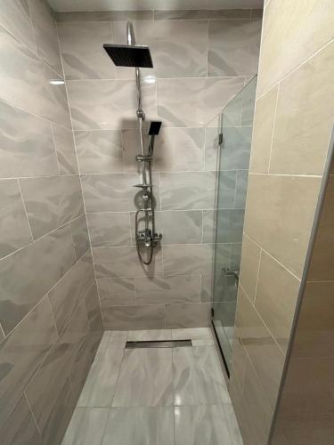 a shower with a glass door in a bathroom at Lagodekhi Inn in Lagodekhi