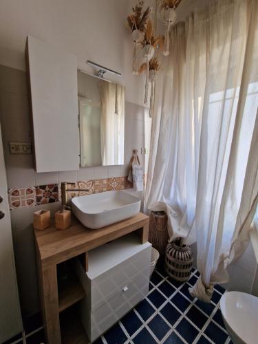 a bathroom with a sink and a toilet and a mirror at Cerry's Apartments Fronte Mare - Seaside & Sealight in Fossacesia