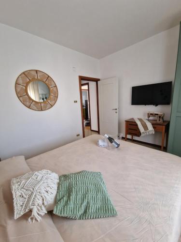 a bedroom with a bed with a mirror on the wall at Cerry's Apartments Fronte Mare - Seaside & Sealight in Fossacesia