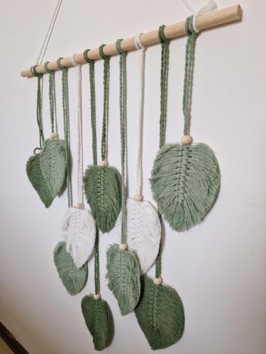 a bunch of knitted leaves hanging on a wall at Cerry's Apartments Fronte Mare - Seaside & Sealight in Fossacesia