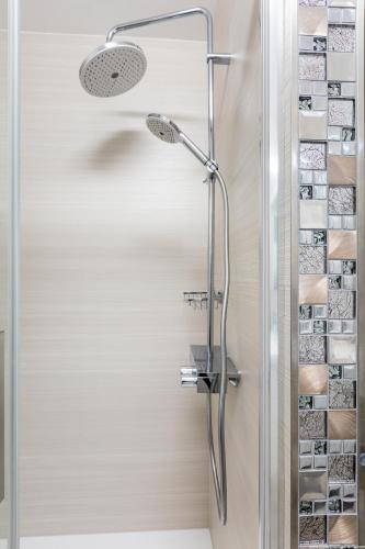 a shower in a bathroom with a glass door at Apartamenty Los Geranios 110 in Playa de las Americas