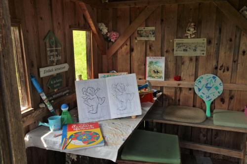 a room with a table with drawings on it at Bocksleitnerhof in Wackersberg