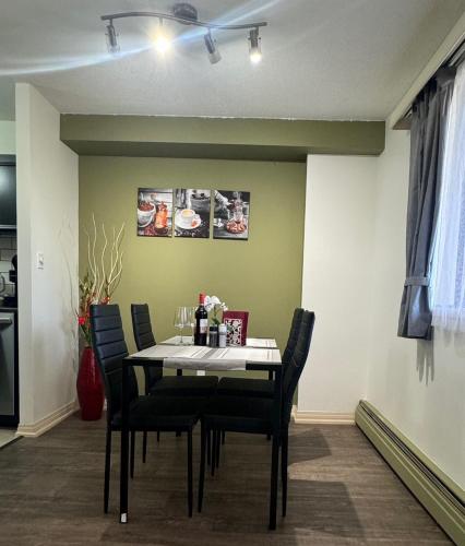 a dining room with a table and chairs at Entire Apartment Prime Downtown location Free underground Parking in Calgary