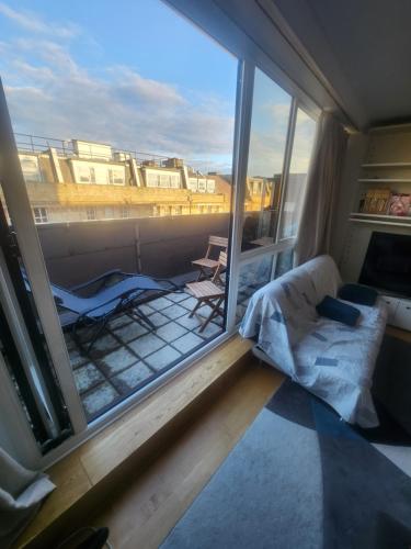 a room with a bed and a large window at Cavaye house in London
