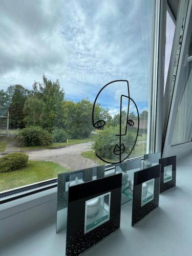 a window with three framed photographs on a glass table at Suuremõisa Holiday Apartment with Sauna in Suuremõisa