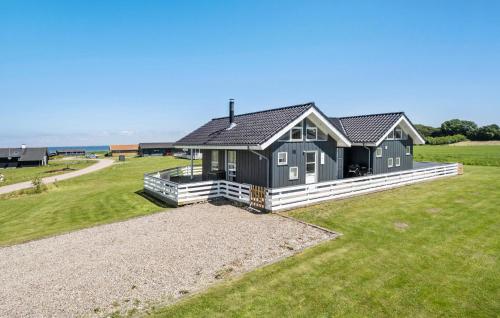 a house on a grassy field with a house at Amazing Home In Nordborg With Wifi in Nordborg