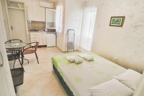 a small room with a bed and a table in it at Ratac Eco Guest House in Sutomore