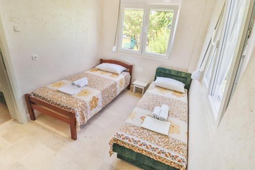 a small room with two beds and a window at Ratac Eco Guest House in Sutomore