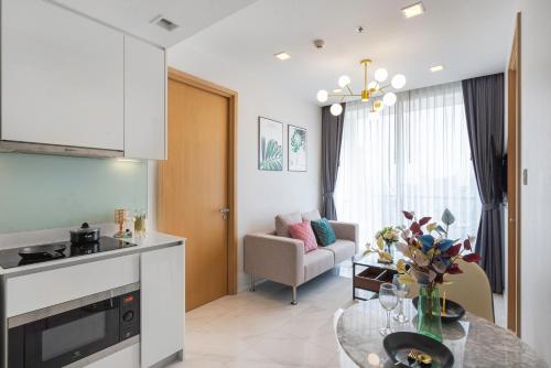 a kitchen and a living room with a table at The Echelon Sukhumvit 11 by LeFoyer in Bangkok