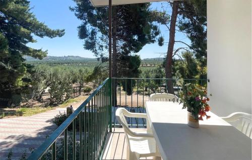 a white table and chairs on a balcony with a view at Nice Apartment In Vieste With Wifi in Vieste