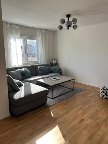 a living room with a couch and a table at Boende på Blekinge Hasslö nära badstrand in Hasslö