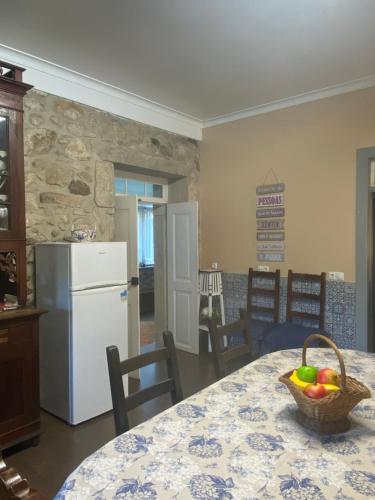 a kitchen with a table with a basket of fruit on it at Casa do Carqueijo in Vila Praia de Âncora