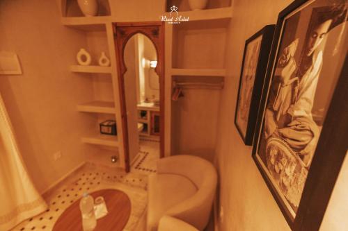 a small bathroom with a toilet and a mirror at Riad Aslal in Marrakech