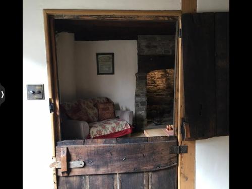 a living room with a couch inside of a door at The Medlar in Kington