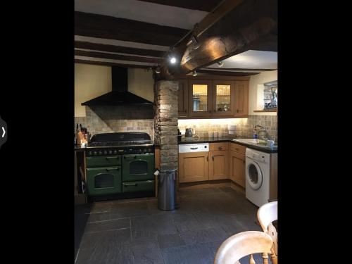a kitchen with a stove and a green oven at The Medlar in Kington