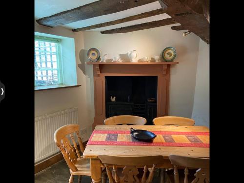 a dining room with a wooden table and chairs at The Medlar in Kington