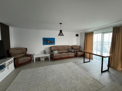 a living room with a couch and a table at Lazăr Home in TÄƒuÅ£ii MÄƒgheruÅŸ