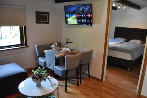 a small living room with a table and a bed at långstorp 200 HÖÖR stugan in Långstorp
