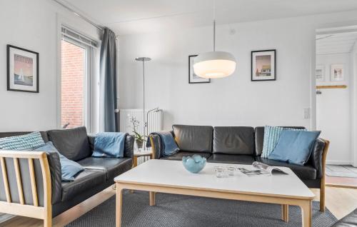 a living room with a couch and a table at Apartment No 195 in Sønderby