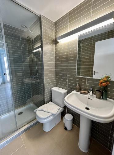 a bathroom with a toilet and a sink and a shower at Casa Pueblo Ciutadella in Ciutadella