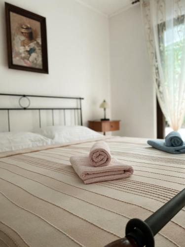 a bedroom with a bed with two towels on it at VILLA MARE in Supetar