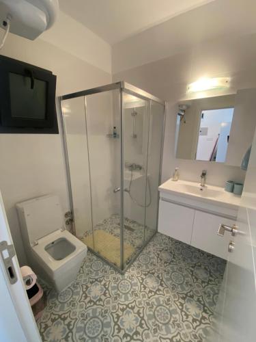 a bathroom with a shower and a toilet and a sink at Caesar Resort & SPA - Studio Apartment - Amelius in Iskele