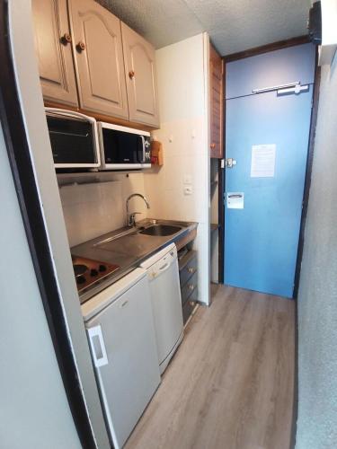 une petite cuisine avec un évier et un réfrigérateur dans l'établissement Résidence Diamant - Studio pour 4 Personnes 094, à Aime La Plagne