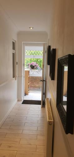 a hallway with a door leading into a room at Rose Homestay Brighton - Free parking Ensuite studio room near Brighton Uni in Brighton & Hove