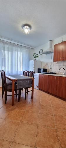 a kitchen and dining room with a table and chairs at Gościniec Joanna in Rajgród