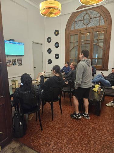 a group of people sitting at tables in a room at Play Hostel Arcos in Buenos Aires