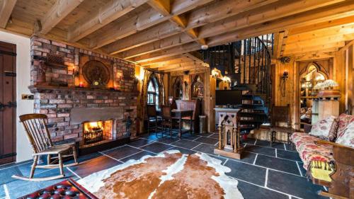 a living room with a fireplace and a couch at Heathfield Hall, Hillsborough - The Coach House in Annahilt