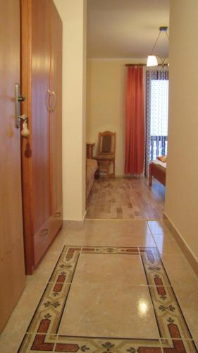 a room with a hallway with a door and a living room at Penzión pod Barancom in Žiar
