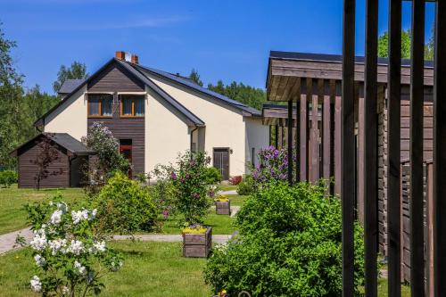 a house with a garden in front of it at Rīteņi in Ķesterciems
