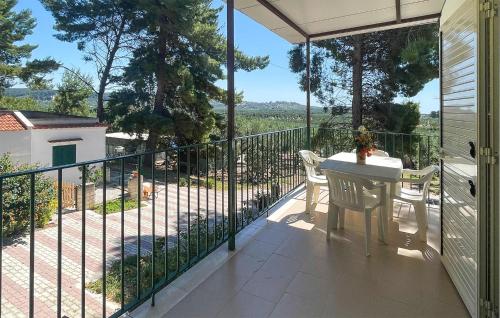 a patio with a table and chairs on a balcony at Beautiful Apartment In Vieste With Wifi in Vieste