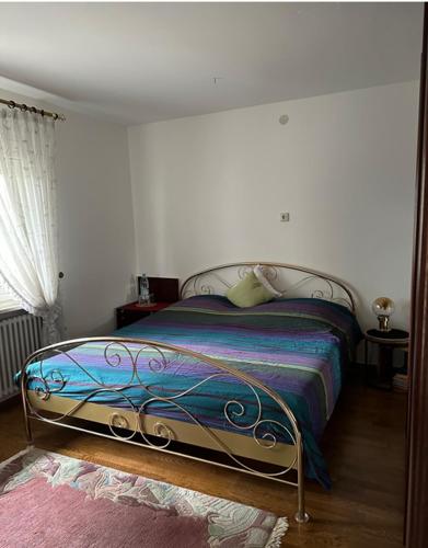 a bedroom with a bed with a metal frame at Haus Anneliese in Herbolzheim