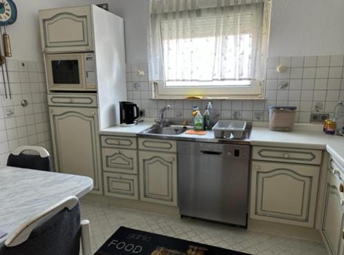 a kitchen with a sink and a microwave at Haus Anneliese in Herbolzheim