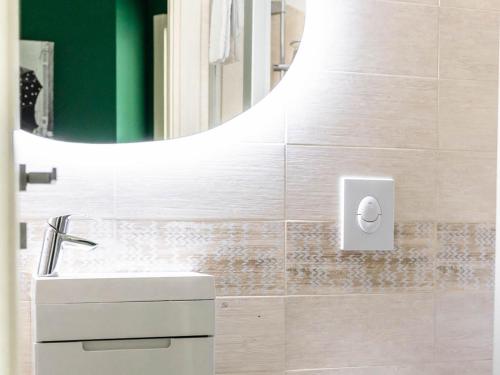 a bathroom with a sink and a mirror at Serenity with swimming pool and parking in Alassio in Alassio