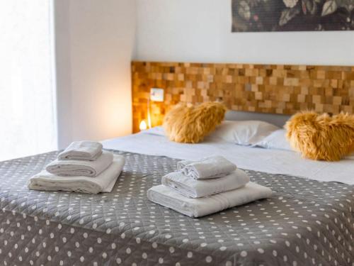 a bed with towels and stuffed animals on it at Serenity with swimming pool and parking in Alassio in Alassio