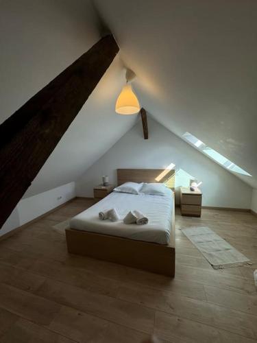 une chambre avec un lit dans un grenier dans l'établissement Le Petit Nid de Colmar - Parking privé, à Colmar