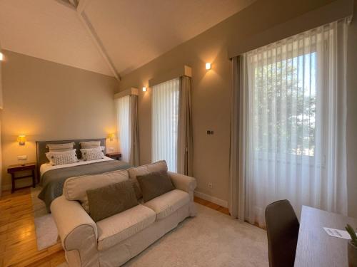 a living room with a bed and a couch at BlueCap by MyTrip Porto in Matosinhos