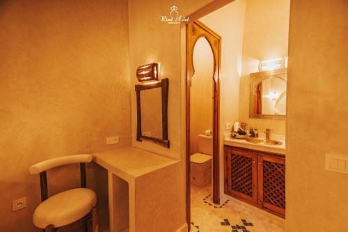 a small bathroom with a sink and a mirror at Riad Aslal in Marrakech