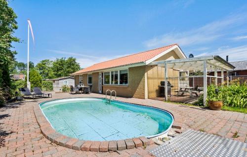 a swimming pool in front of a house at 3 Bedroom Awesome Home In Videbæk in Videbæk
