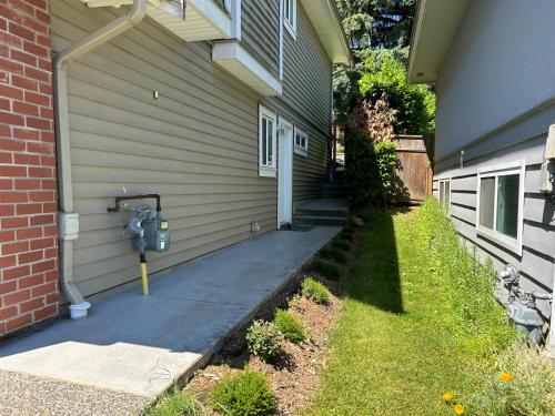 a house with a parking meter next to a driveway at A private suite in Port Moody in Port Moody