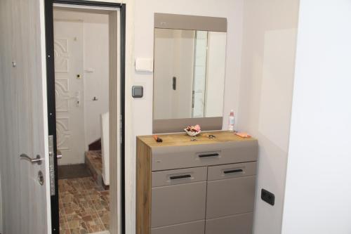 un baño con lavabo y espejo en First Line Apartment, en Balchik