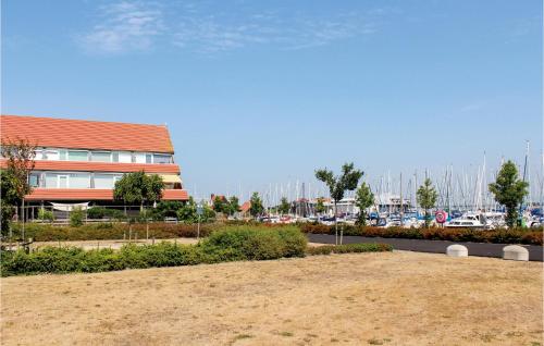 a view of a marina with a building and boats at Nice Apartment In Bruinisse in Bruinisse