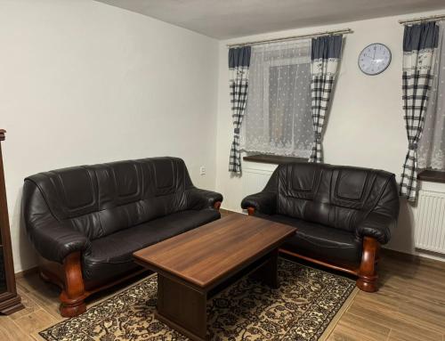 a living room with a leather couch and a coffee table at Chalupa Dubné-Křenovice4 in České Budějovice