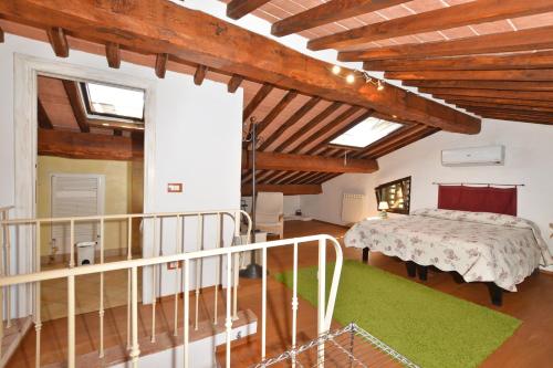 a bedroom with a bed in a room with wooden ceilings at Da Maria - Happy Rentals in Murlo