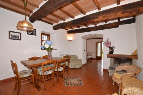 a dining room with a table and chairs and a fireplace at Villa La Chiesina - Happy Rentals in Arcidosso