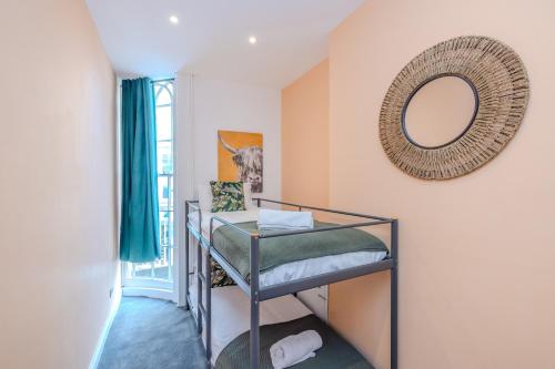 a room with two bunk beds and a mirror at 2 Bedroom Flat Next To Brighton Beach in Brighton & Hove