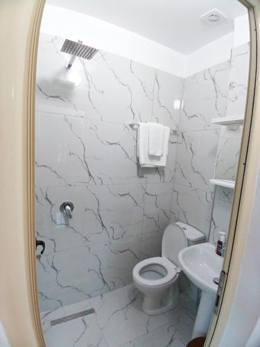 a bathroom with a toilet and a sink at Taku Rooms Vlora 2 in Vlorë